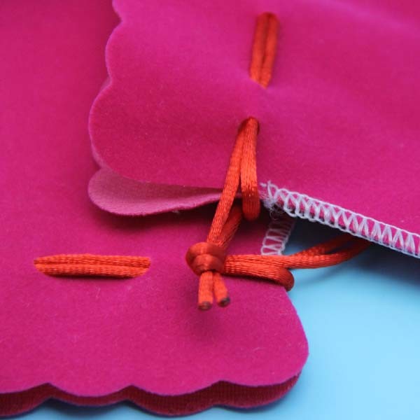 small velvet drawstring gift bag with satin lining inside with gold logo stamped