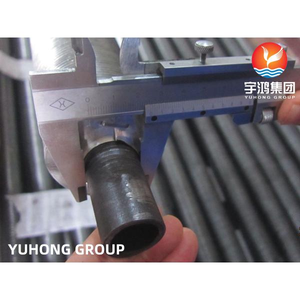 Wound fin tube product sample showing aluminum fins wound around steel base tube